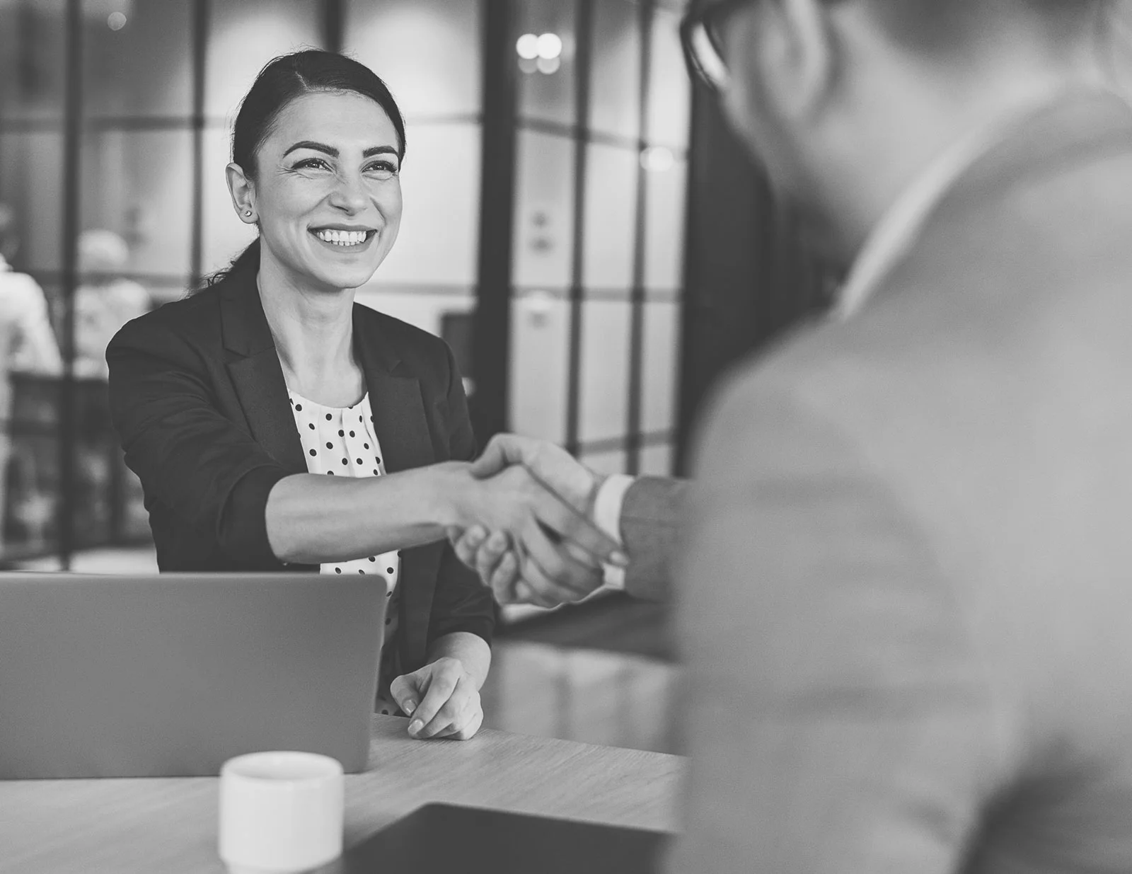 A person shakes hands with another person