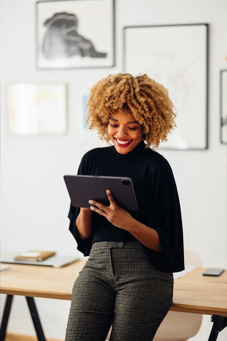 An person smiles at their tablet